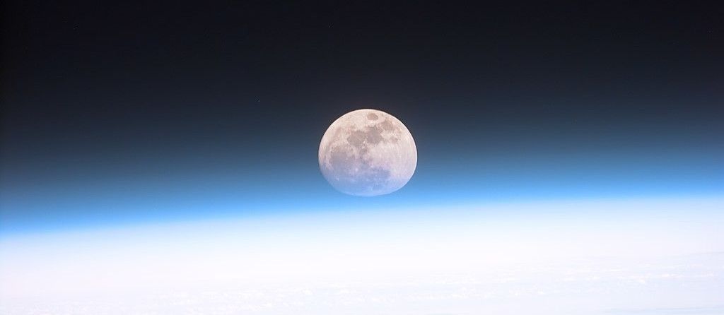 Explore the challenges and opportunities of moon exploration and exploitation, including geopolitical, economic and technological aspects. /articles/moon-race-challenges-opportunities/Full_moon_partially_obscured_by_atmosphere-1.jpg